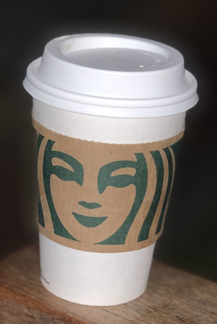 CLOSE-UP OF TEA CUP ON WHITE TABLE