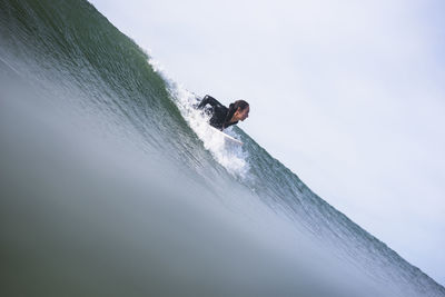 Woman surfing in rhode island summer