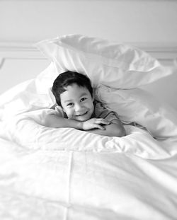 High angle view of girl lying on bed