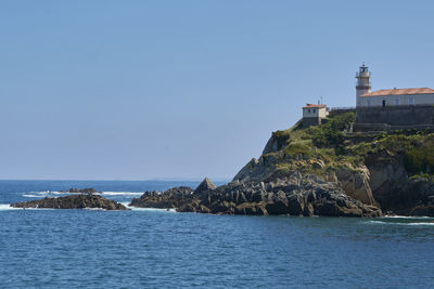 Ocean coast with lighthouse and cliff, colors of nature