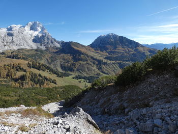 Scenic view of mountains against blue sky