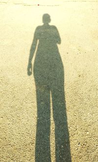 Shadow of person on road