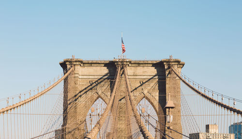 Low angle view of suspension bridge against clear sky