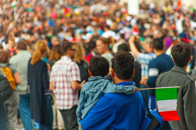 Rear view of people standing on street