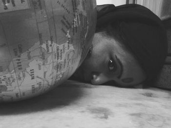 Close-up portrait of young woman lying on bed at home