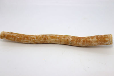 Close-up of bread on table against white background