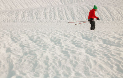 Man skiing on snow covered field