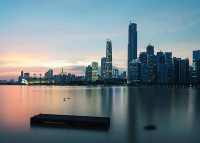 Cityscape against sky at sunset