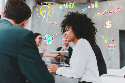 Side view of business colleagues working at office