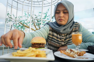 Woman enjoying food and drink in cafe