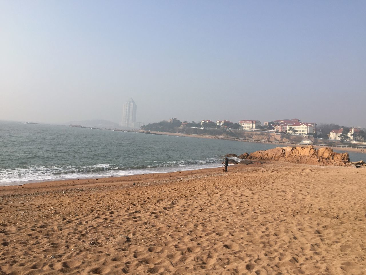 beach, water, sea, built structure, architecture, sand, clear sky, shore, copy space, building exterior, city, cityscape, travel destinations, coastline, wave, surf, tourism, famous place, incidental people, scenics