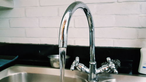 Close-up of faucet in bathroom