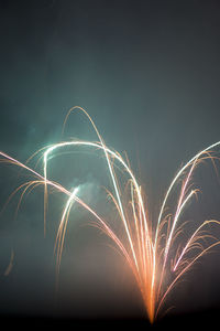 Close-up of illuminated fireworks against sky at night