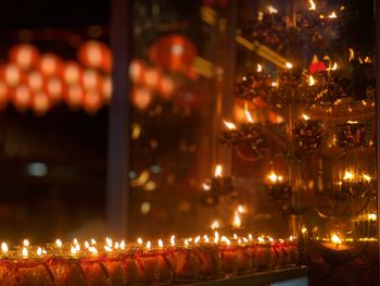 Illuminated candles in temple