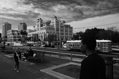 Men in city against sky