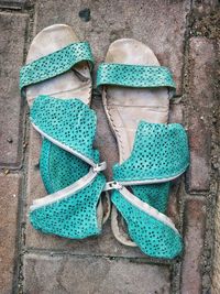 Close-up high angle view of footwear on ground