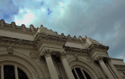 Low angle view of building against cloudy sky