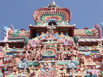 Low angle view of statue against temple building