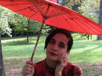 Portrait of mid adult woman holding umbrella during rainy season