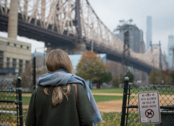 Rear view of woman standing in city