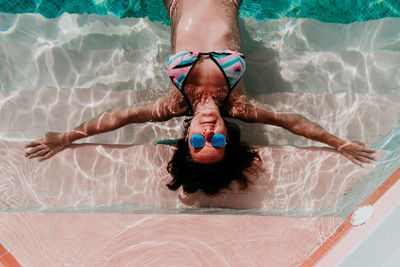 Portrait of shirtless woman in swimming pool