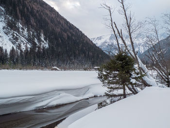 Scenic view of snow covered mountains against sky