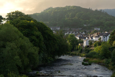 High angle view of river amidst trees against sky