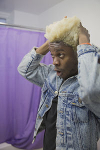 A young man styling his hair