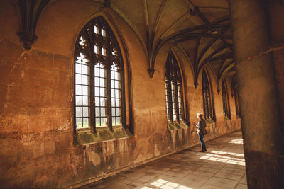 Full length of woman standing in corridor