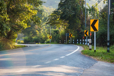 Road sign by trees