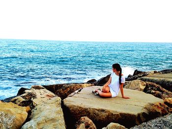 Woman standing on rocks at beach