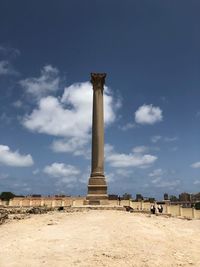 Low angle view of monument against cloudy sky