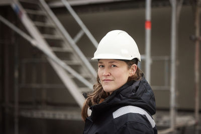 Female engineer standing at building site