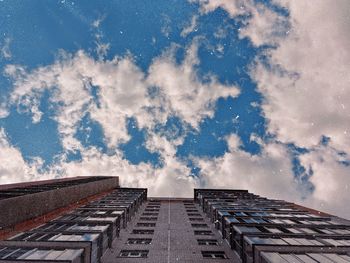 Low angle view of building against cloudy sky