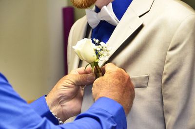 Close-up of couple holding bouquet