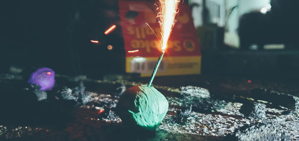 Close-up of burning candles on barbecue grill