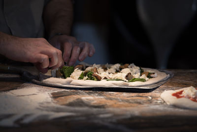 Midsection of man preparing food on table