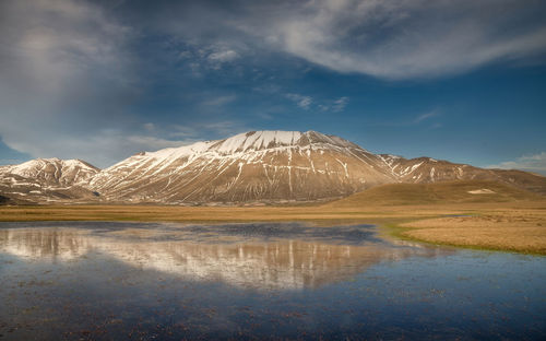 Scenic view of snowcapped mountains against sky