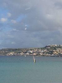 Scenic view of sea against cloudy sky