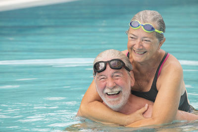 Portrait of smiling man with woman in water