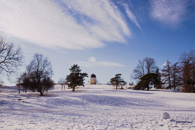 Snow covered field against sky