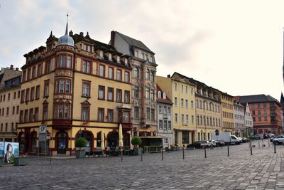 Buildings in town against sky