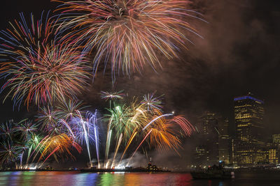 Firework display in city at night