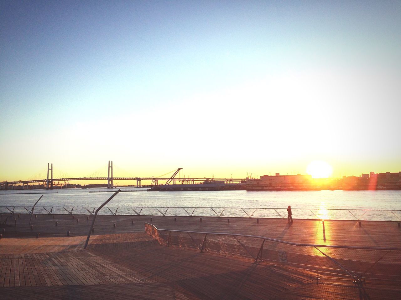 sunset, water, sun, clear sky, sea, sunlight, built structure, copy space, architecture, beach, orange color, nature, reflection, scenics, silhouette, sunbeam, pier, sky, tranquility, tranquil scene