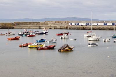 Boats moored in sea against sky