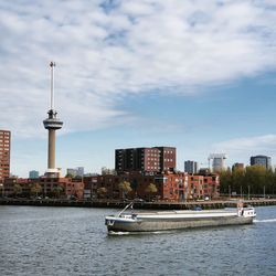 Boats in river with buildings in background