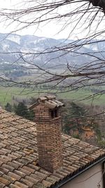 Houses on mountain against sky