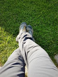 Low section of man standing on field