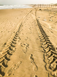 High angle view of tire tracks on beach