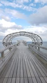 View of pier over sea against cloudy sky